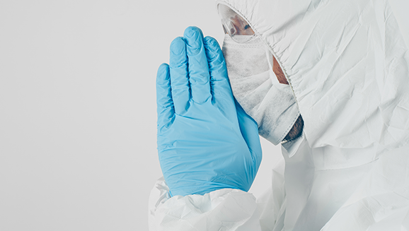 Person in full PPE with mask, gown, and gloves